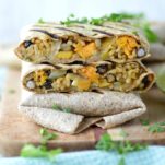 close-up of sweet potato black bean burritos stacked on each other