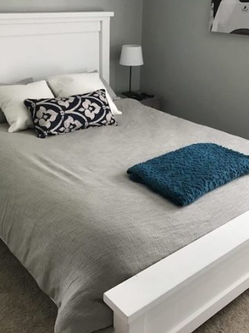 white farmhouse bed with grey comforter