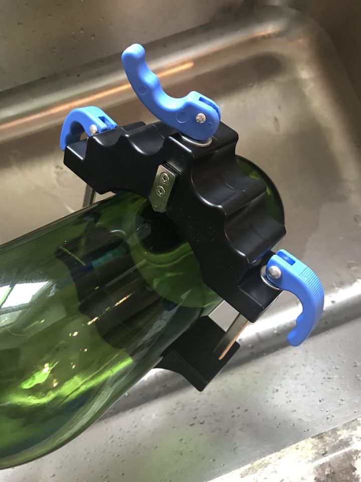 fitting glass cutter to cut wine bottle