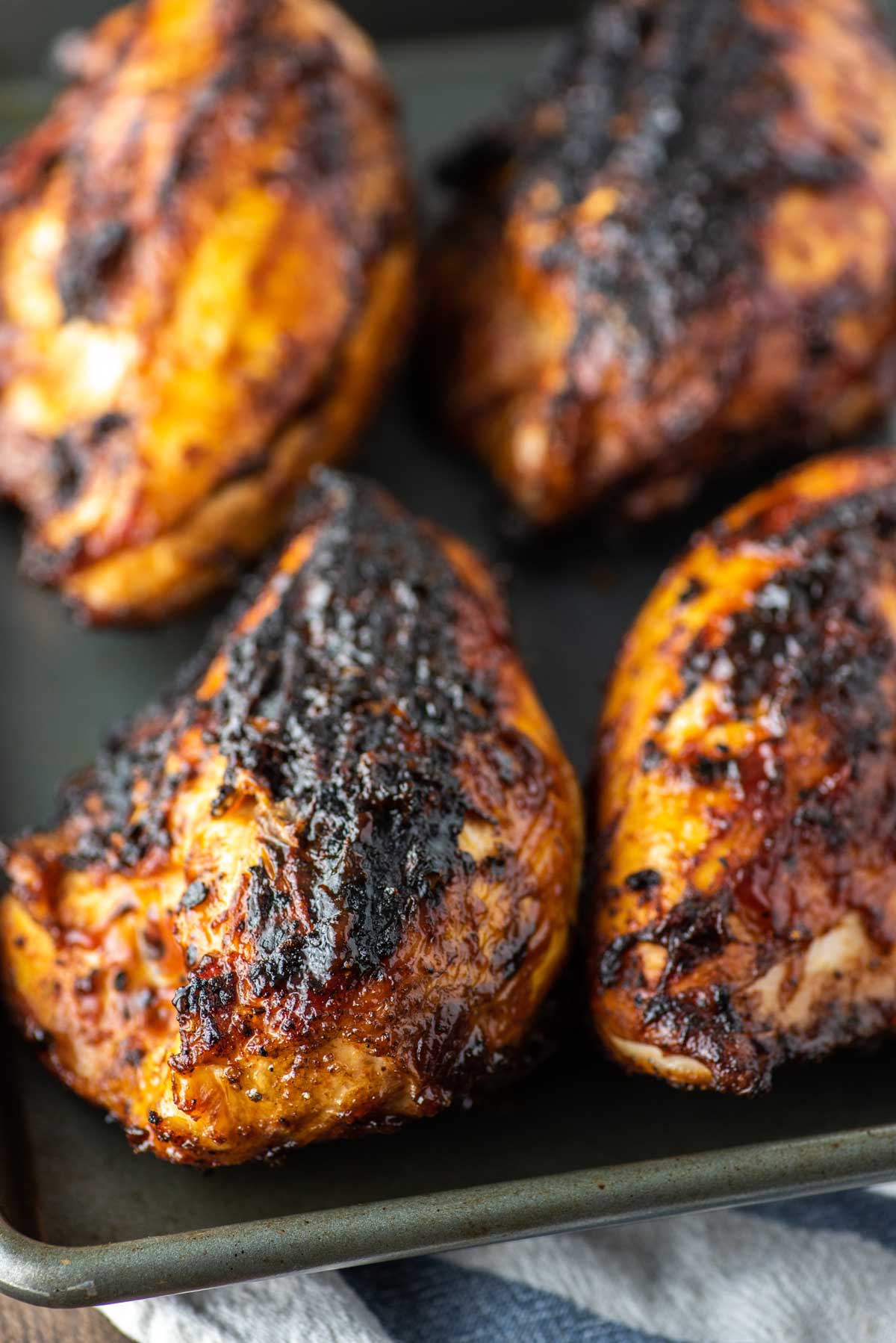 grilled BBQ chicken on baking sheet