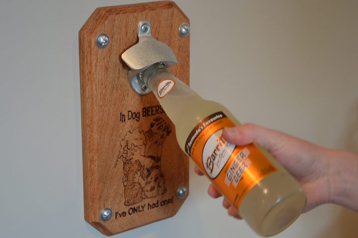 ginger beer being opened with magnetic beer bottle opener