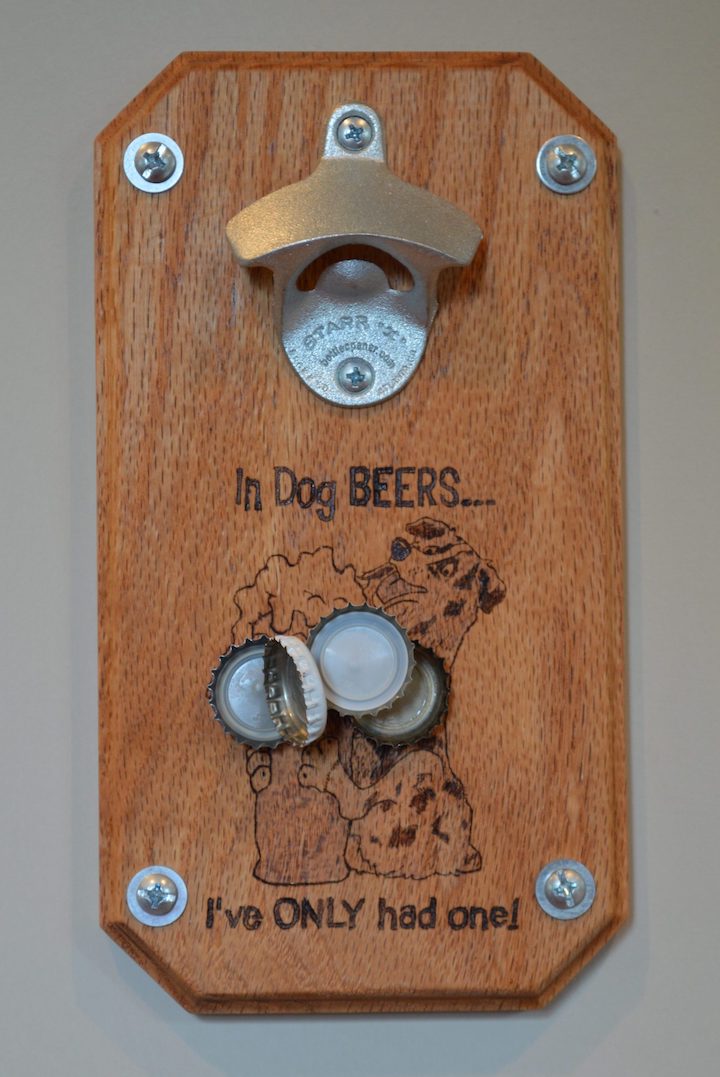 close-up of magnetic beer bottle opener with bottle caps