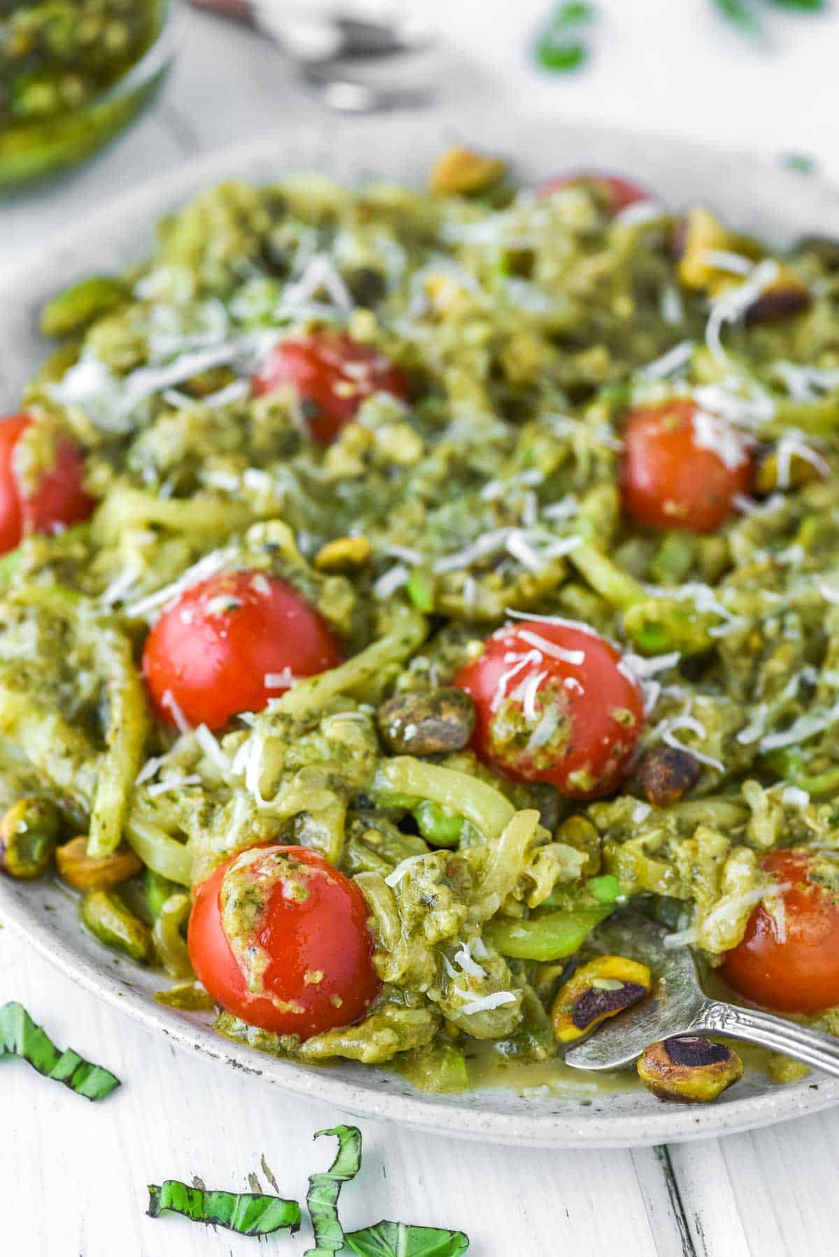 zoodles with pesto and tomatoes on plate