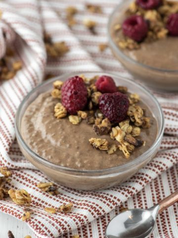 chocolate chia seed pudding in glass bowl on dish towel