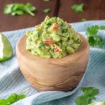 close-up of authentic guacamole in wooden bowl