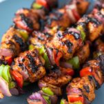 stacked BBQ chicken kebabs on plate