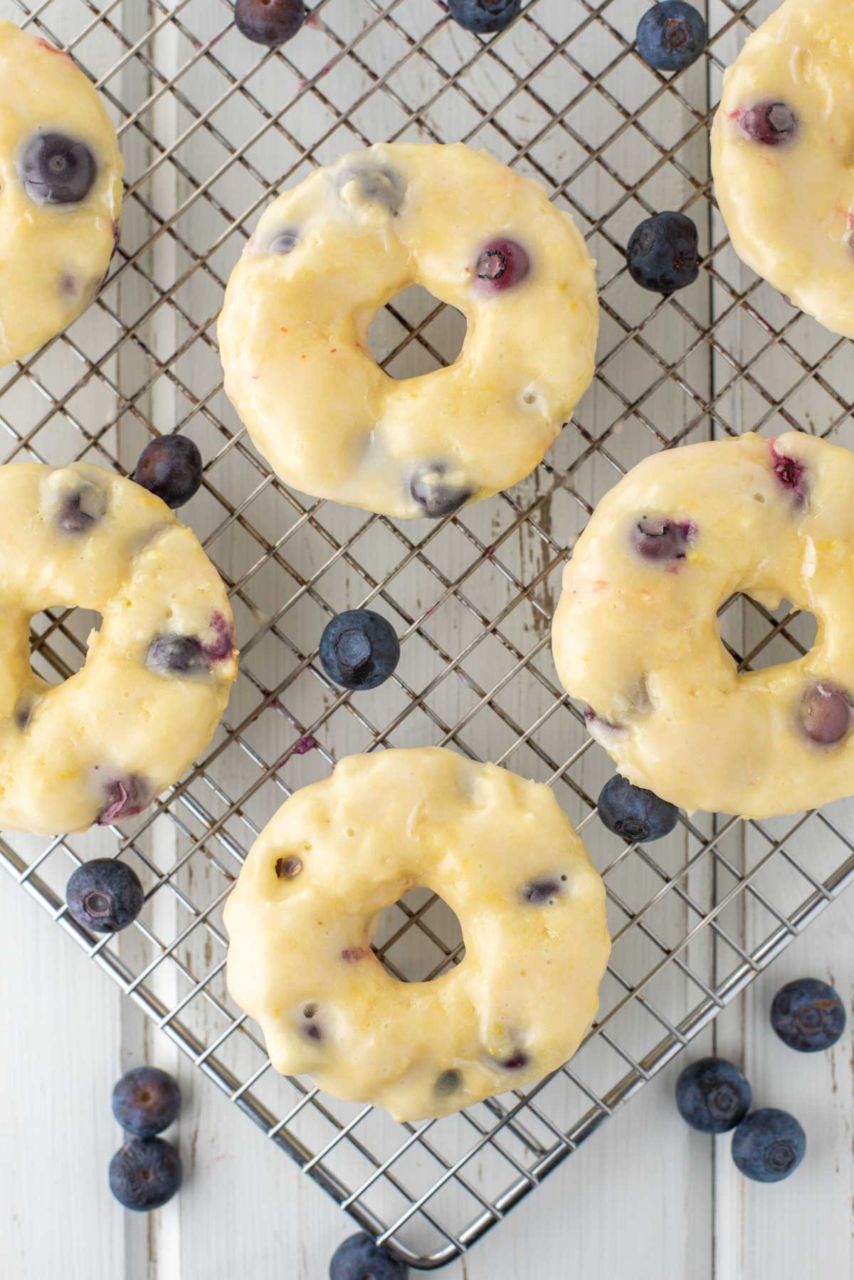 overhead shot of blueberry donuts on cooling rack