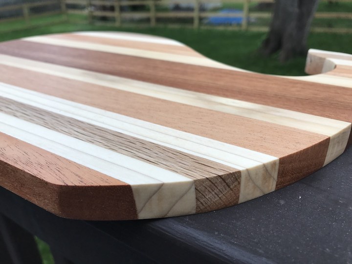 side view of whale cutting board on rail