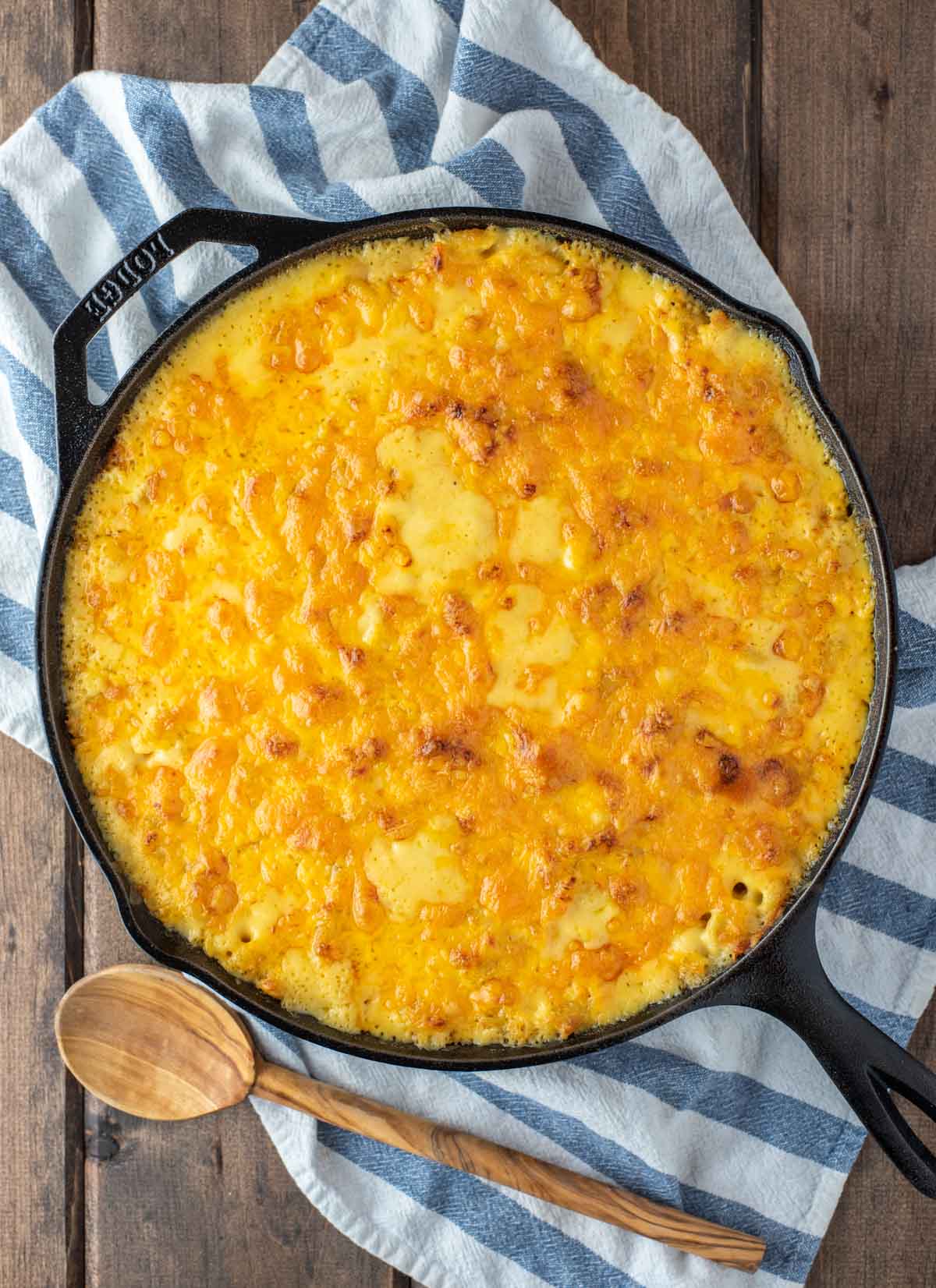 overhead shot of baked cheddar mac and cheese in cast iron skillet