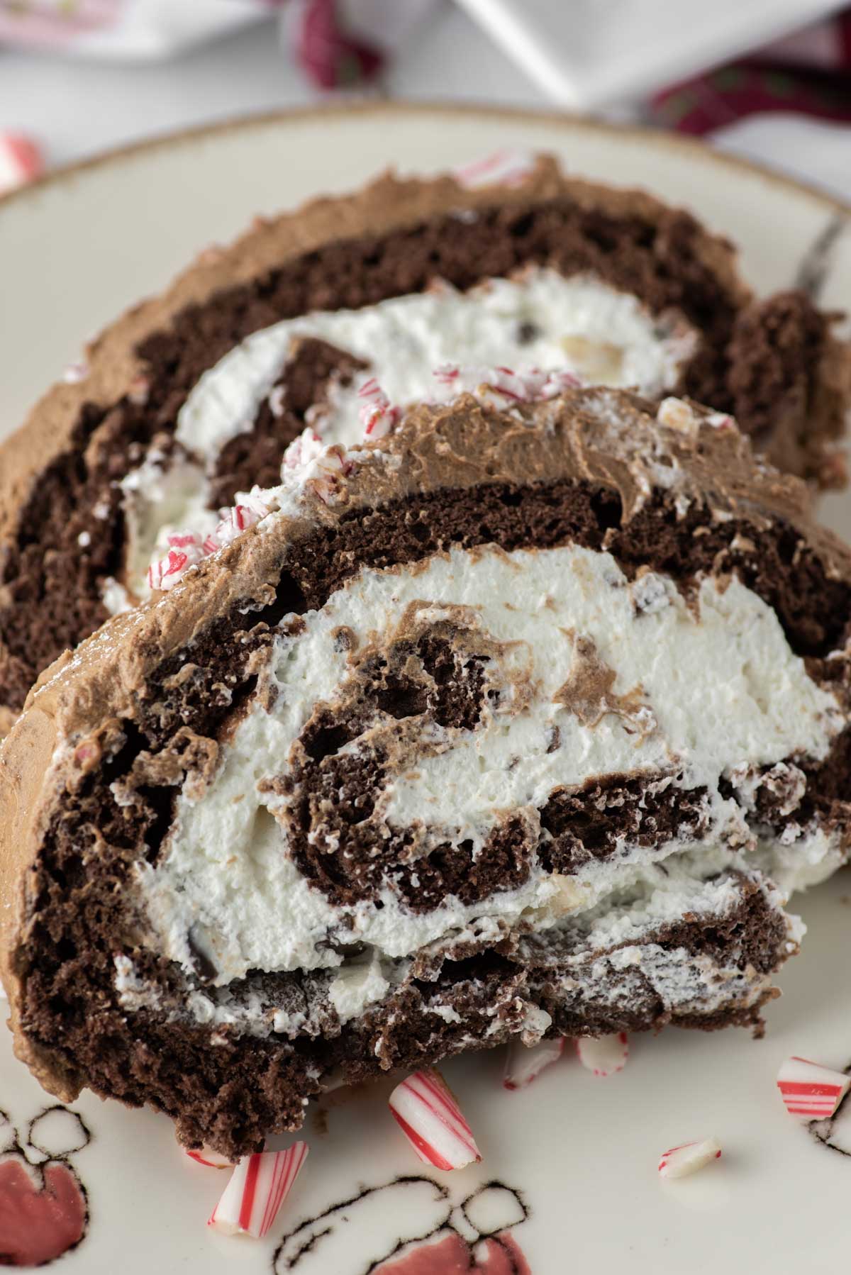 two slices of peppermint bark yule log on plate