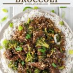 overhead shot of beef and broccoli with chopsticks on plate