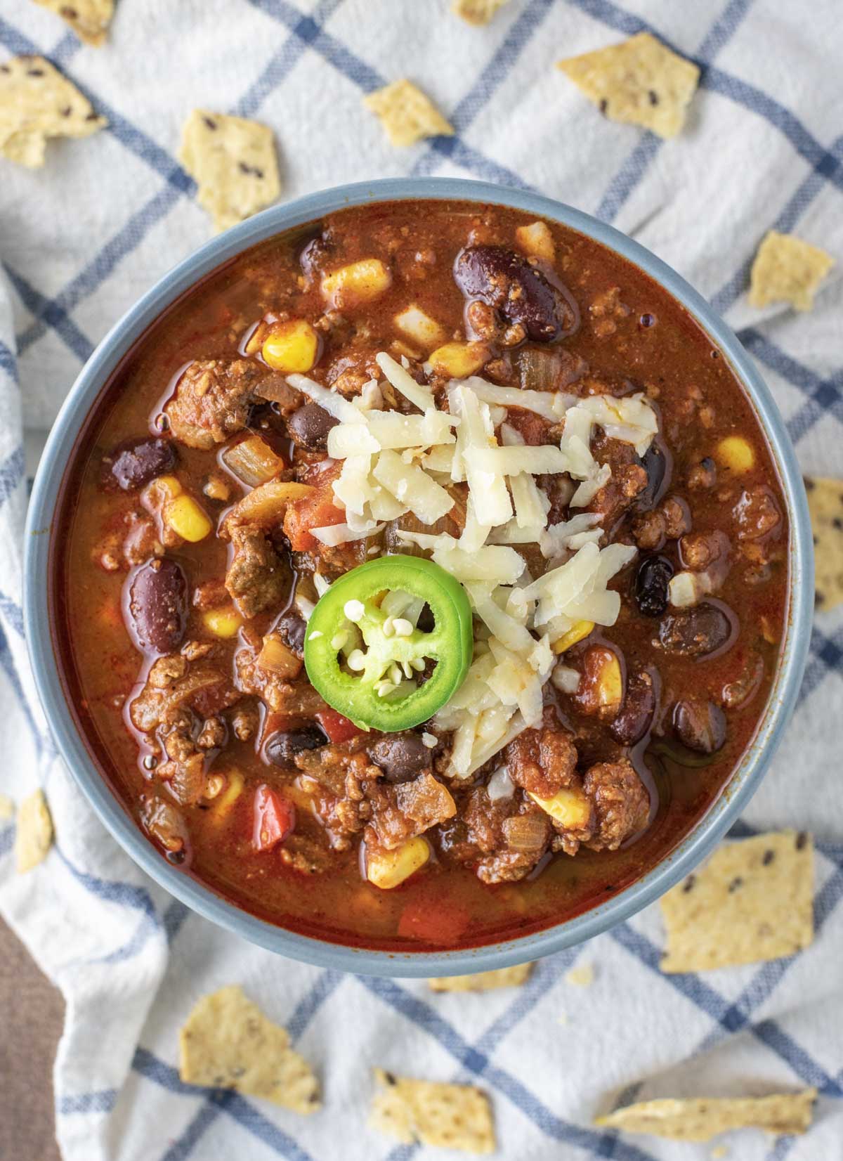 overhead shot of beef chili in blue bowl