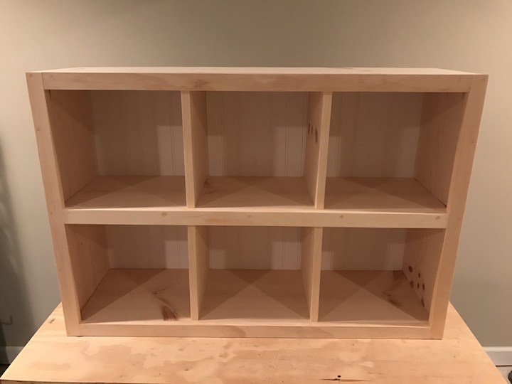 wainscot panel attached to back of 6 cube bookshelf