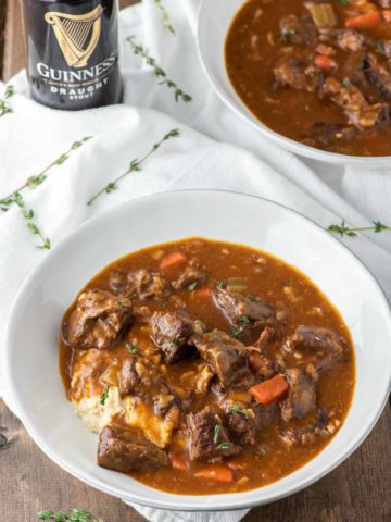 angled shot of Guinness beef stew in two white bowls