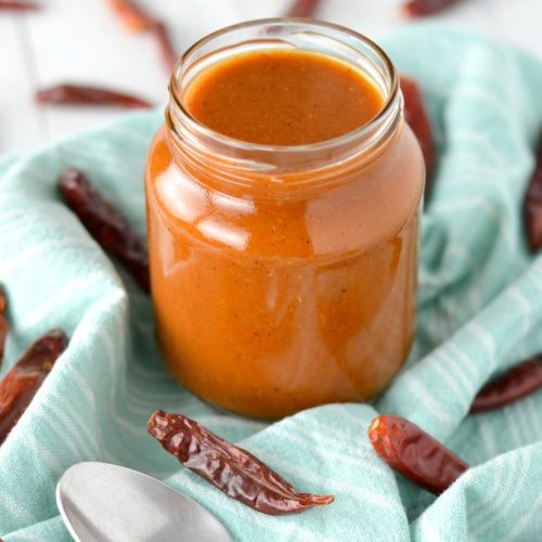 close-up of homemade red enchilada sauce in glass jar