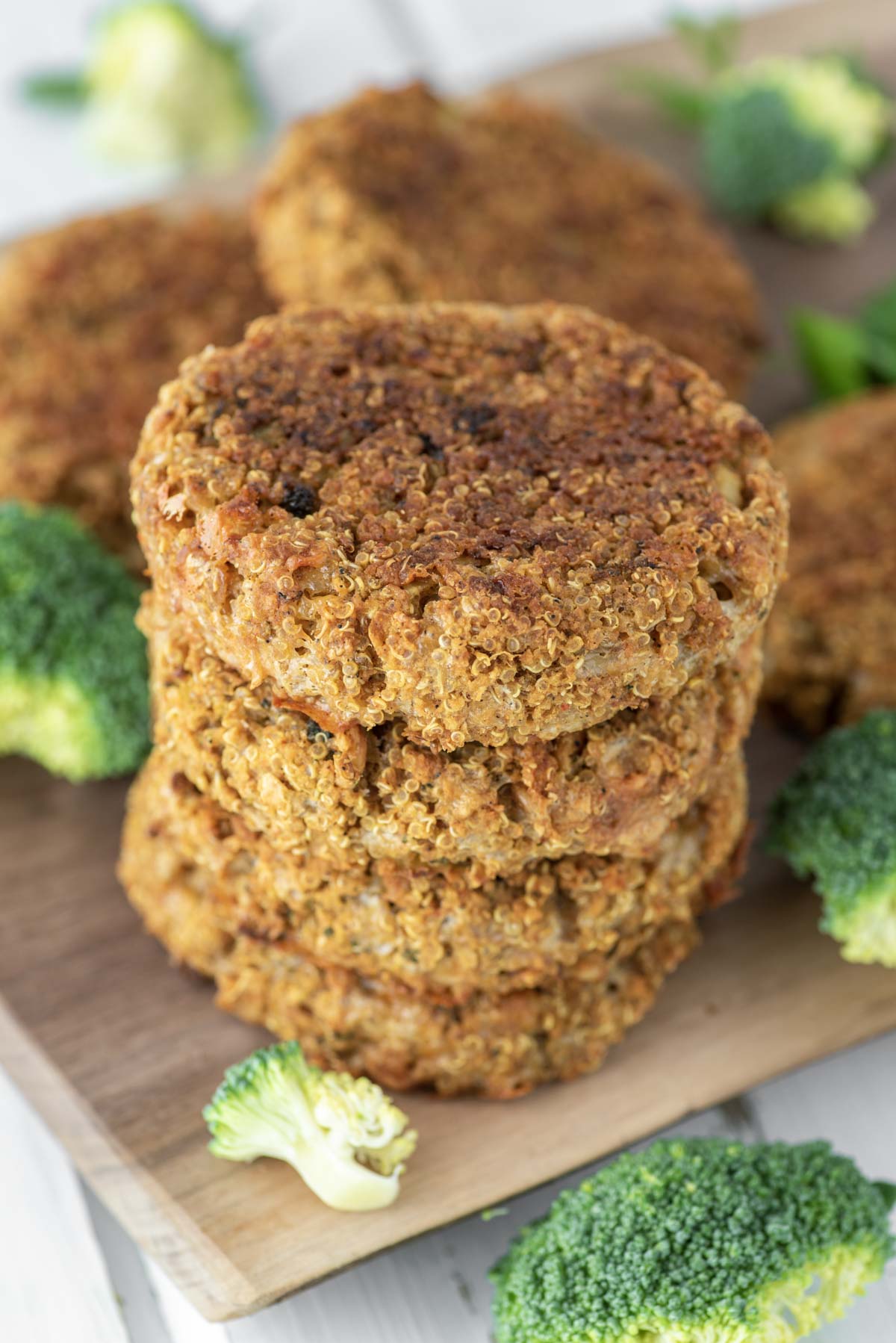 4 quinoa burgers stacked on cutting board