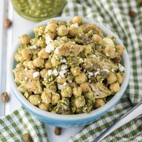 chickpeas with pesto in blue bowl with dish towel