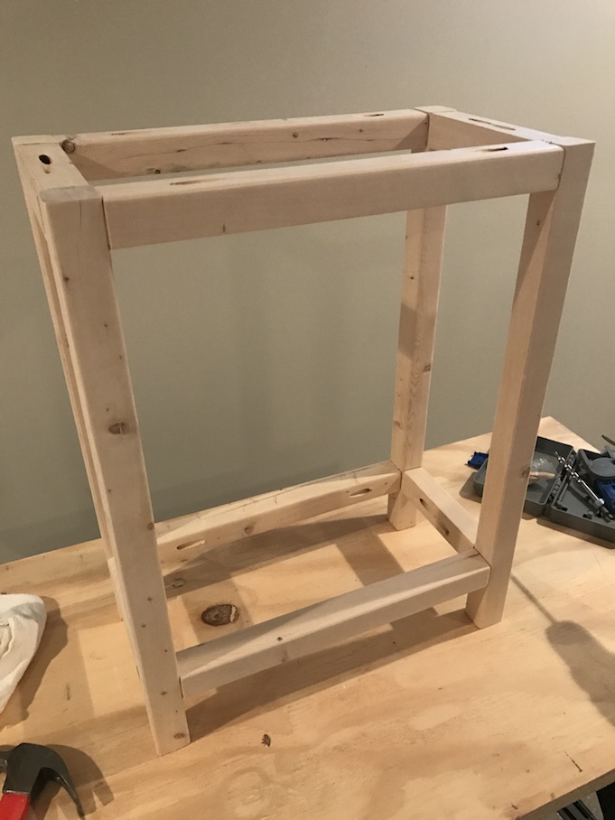 legs for x side table being put together