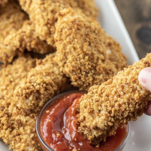 close-up of crispy baked chicken tenders on cutting board