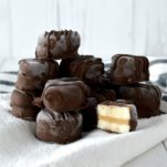 close-up of stacked chocolate peanut butter banana bites on kitchen towel