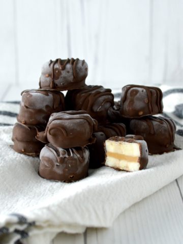 close-up of stacked chocolate peanut butter banana bites on kitchen towel