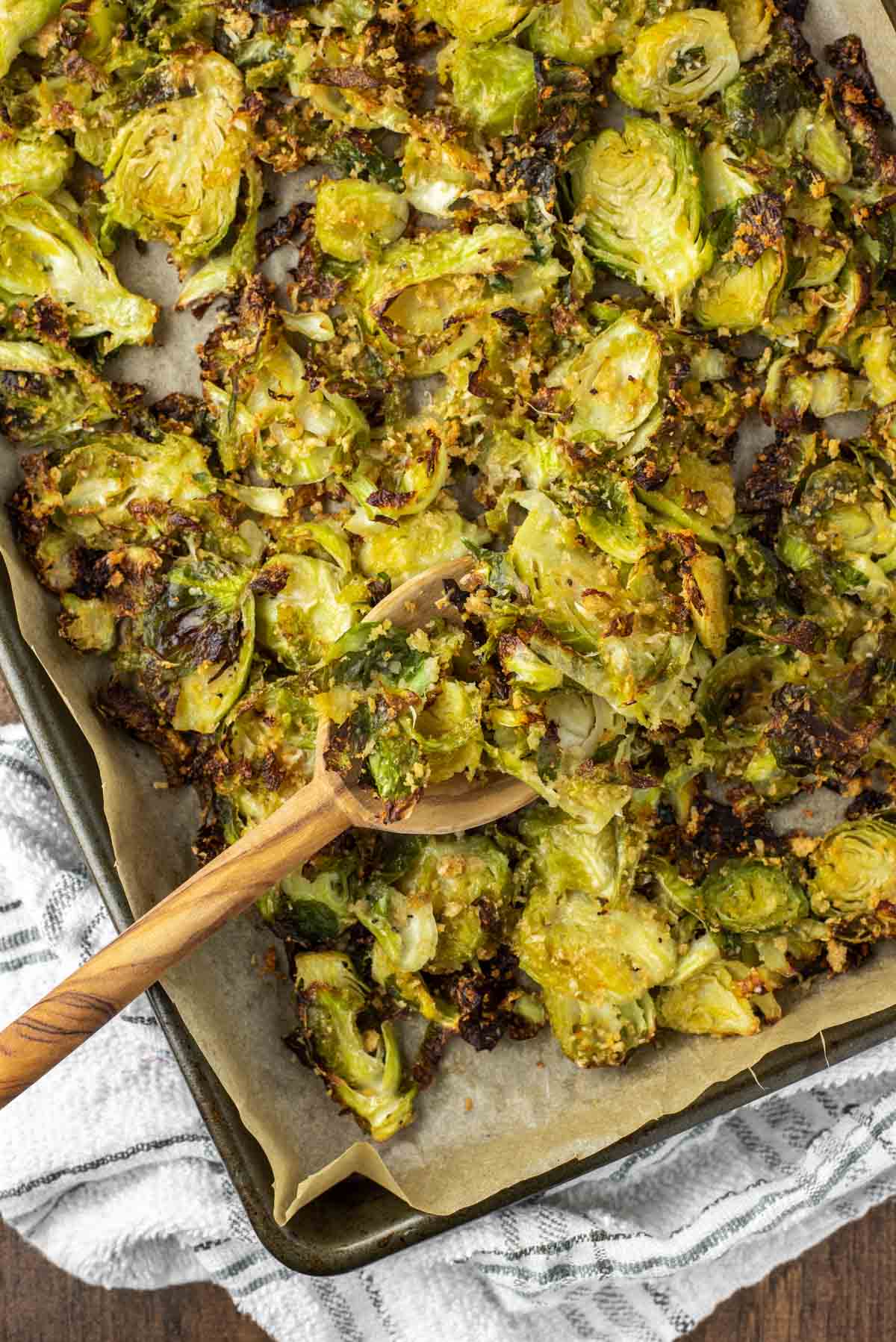 overhead shot of spoon dipped in pan of roasted Brussel sprouts