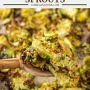 wooden spoon lifting out parmesan roasted Brussel sprouts