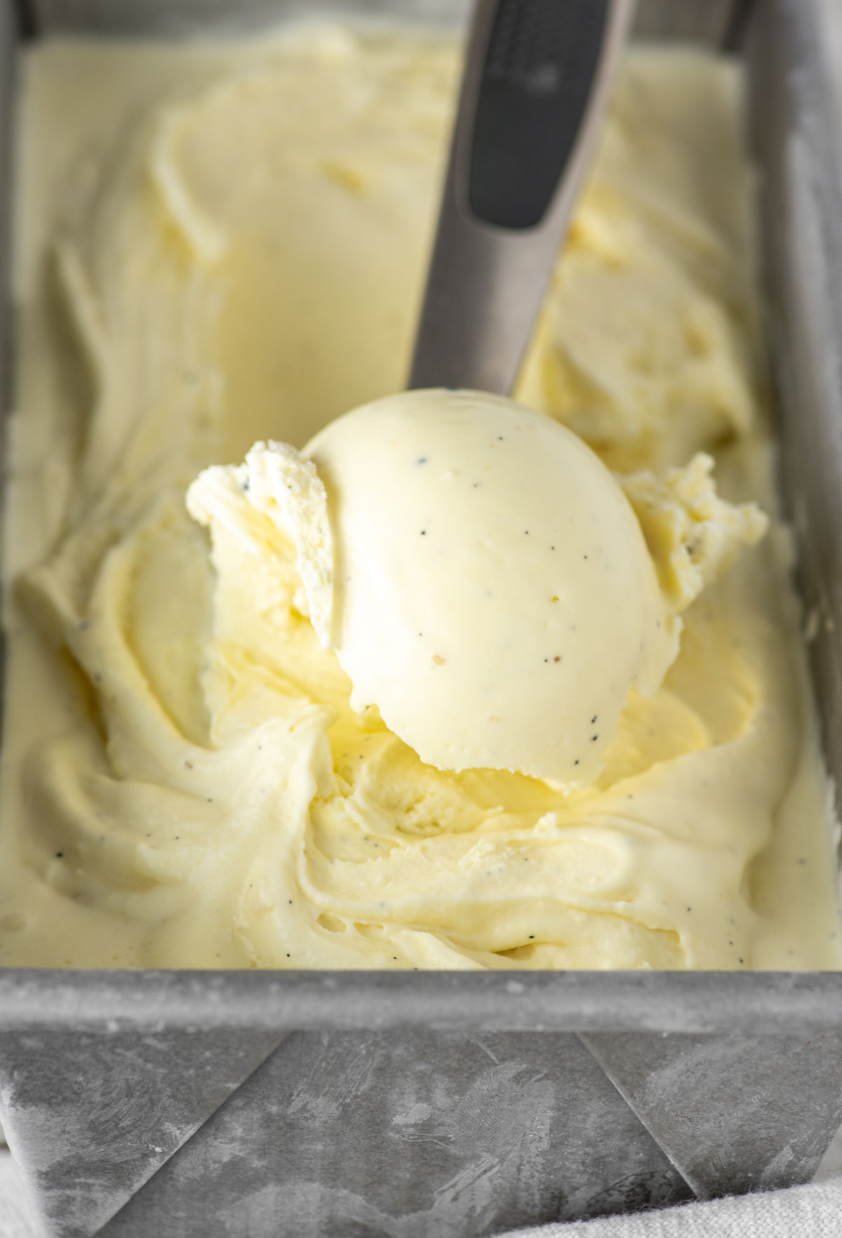 close-up of vanilla bean ice cream in orange bowl