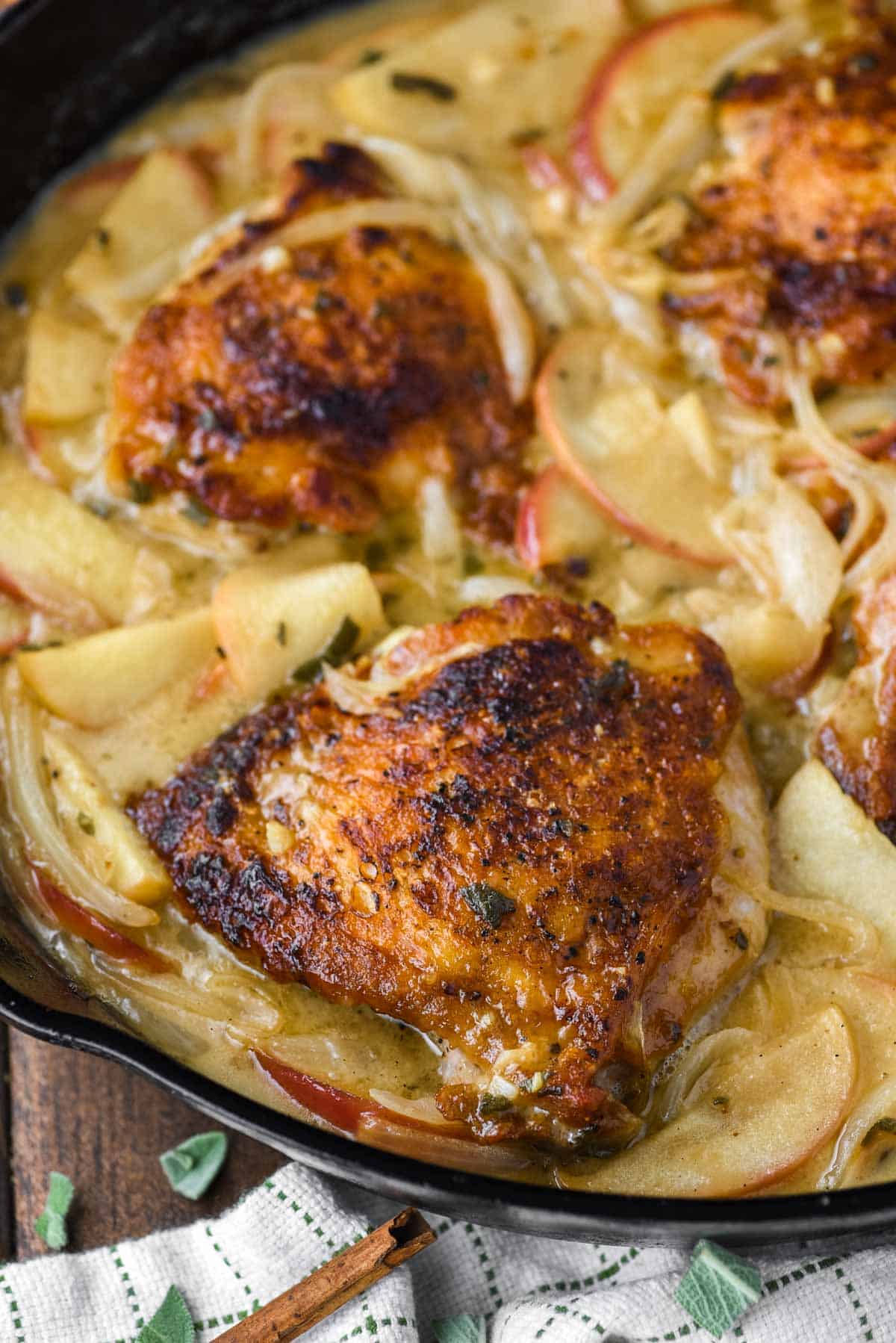 chicken thighs cooked in skillet with sauce