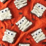 overhead shot of mummy brownies on orange dish towel