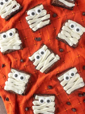 overhead shot of mummy brownies on orange dish towel