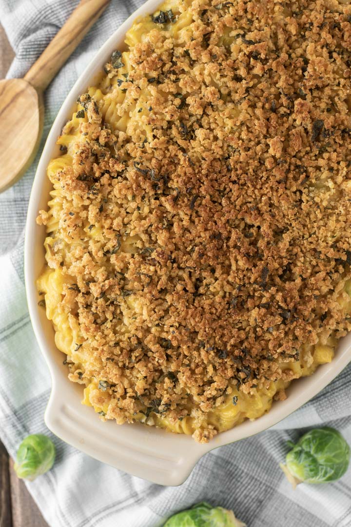 overlay of baked butternut squash mac and cheese in green baking dish