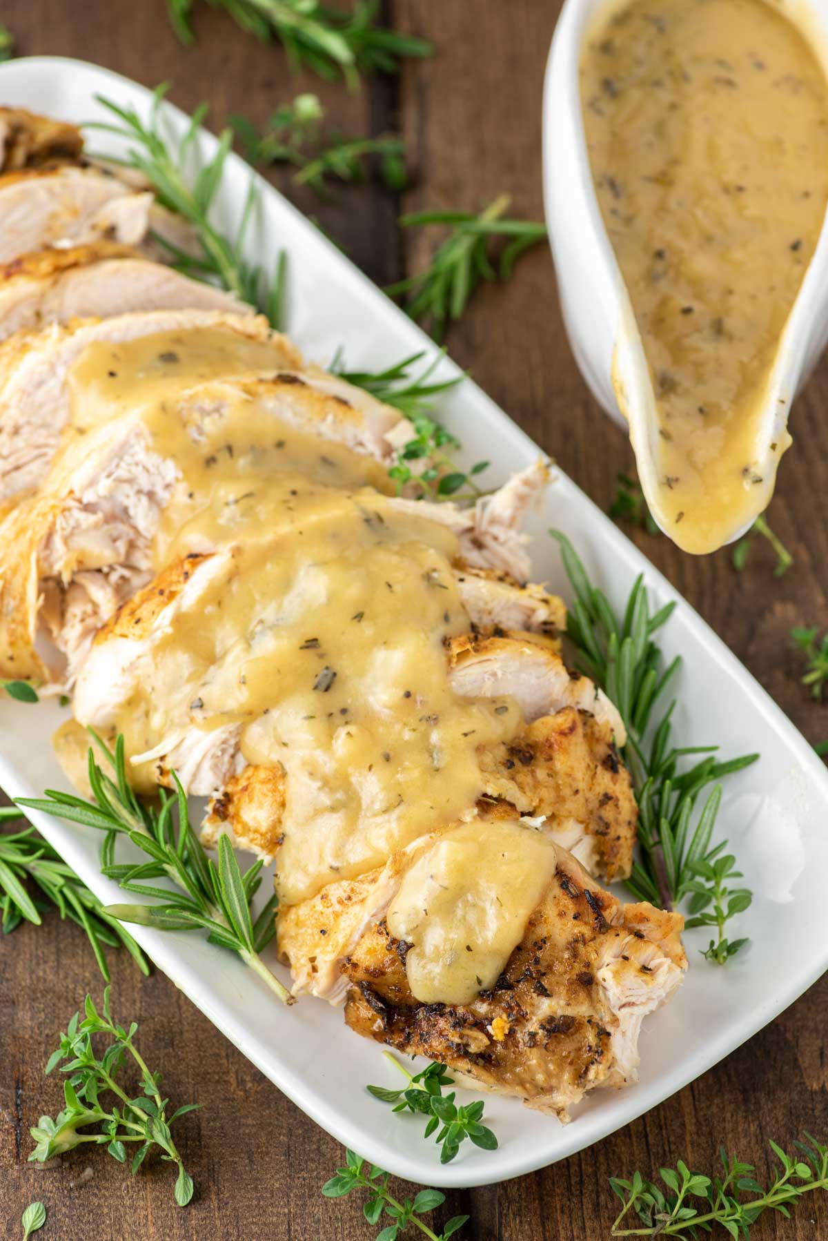 sliced instant pot turkey with gravy on white plate