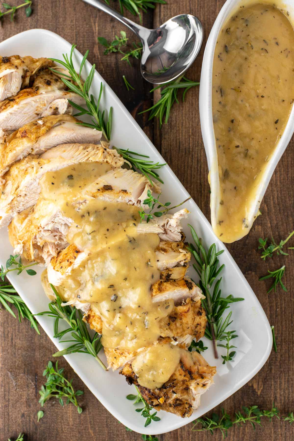 overhead shot of sliced turkey made with instant pot on white plate with gravy