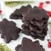 chocolate sugar cookies in shapes of trees stacked on top of each other