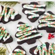 chocolate sugar cookies decorated with icing and sprinkles on white board