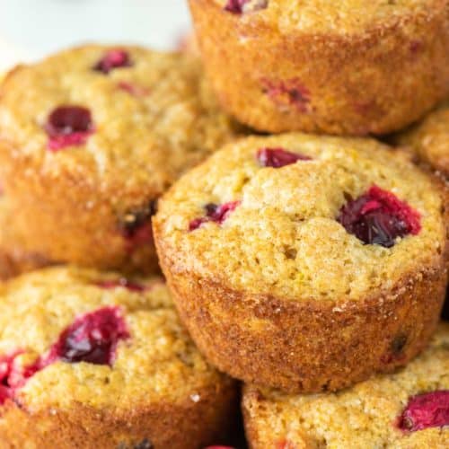 stack of cranberry orange muffins on white plate