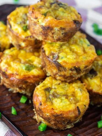 hash brown egg muffins stacked on top of wood board