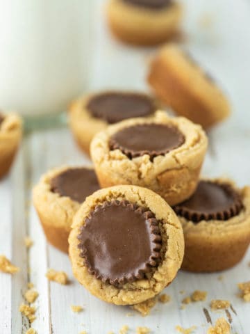 peanut butter cup cookies on white board with milk in background
