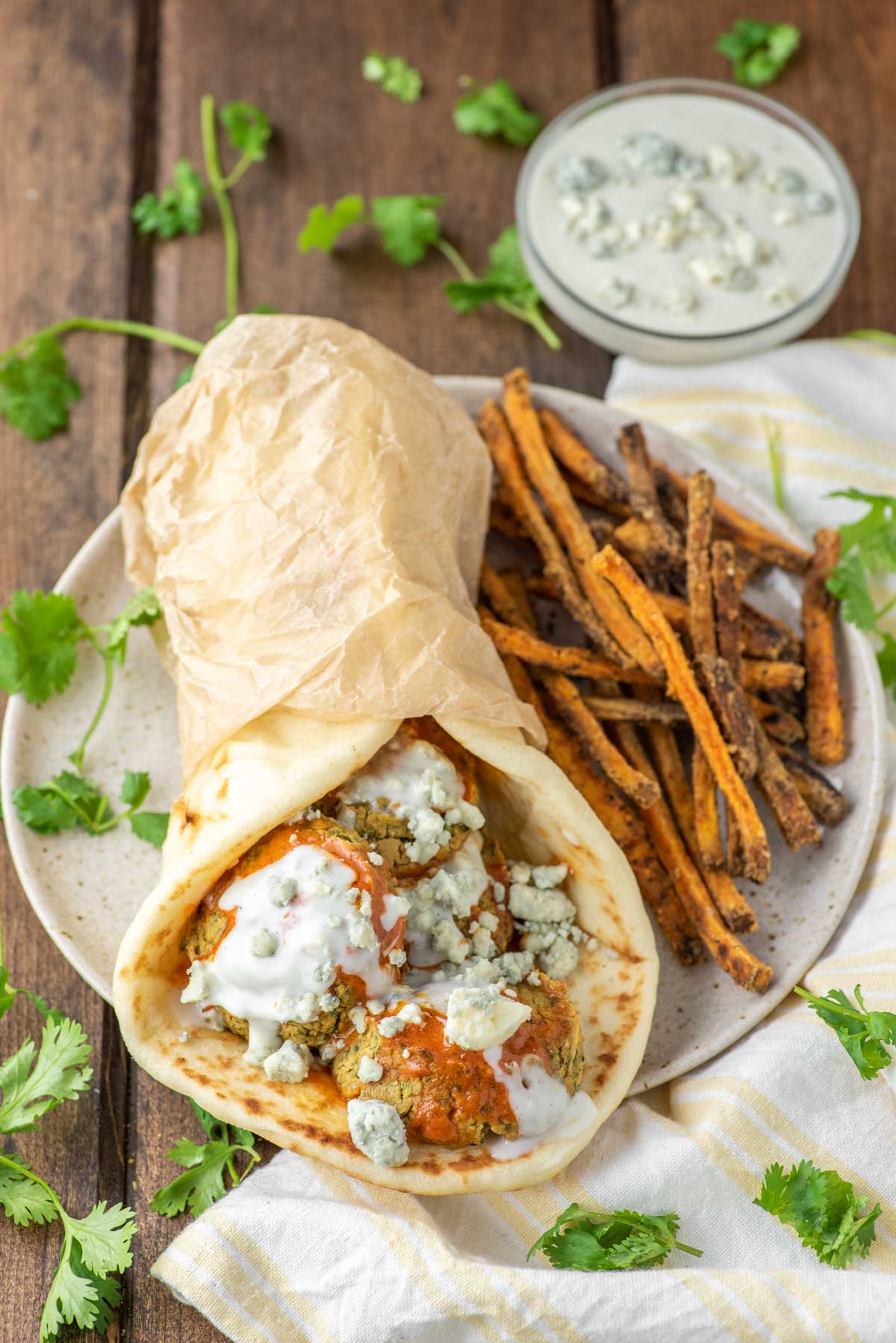 buffalo falafel with naan and sweet potato fries on plate
