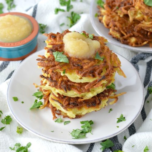 close-up of stacked classic potato latkes on white plate