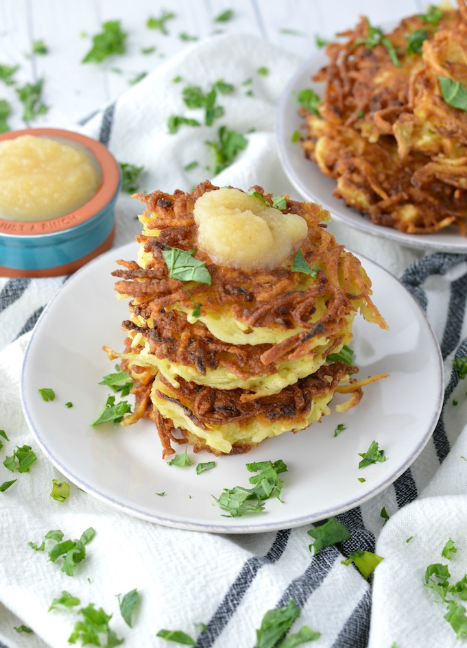 close-up of stacked classic potato latkes on white plate