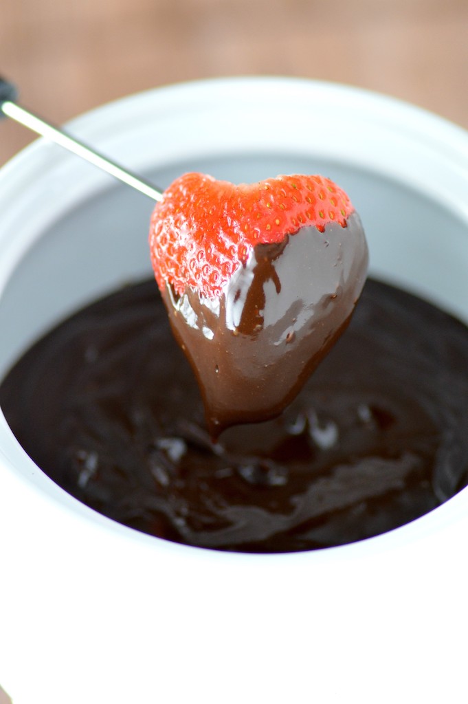 close-up of strawberry dipped in chocolate fondue