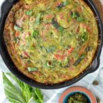 overhead shot of roasted red pepper frittata in cast iron skillet