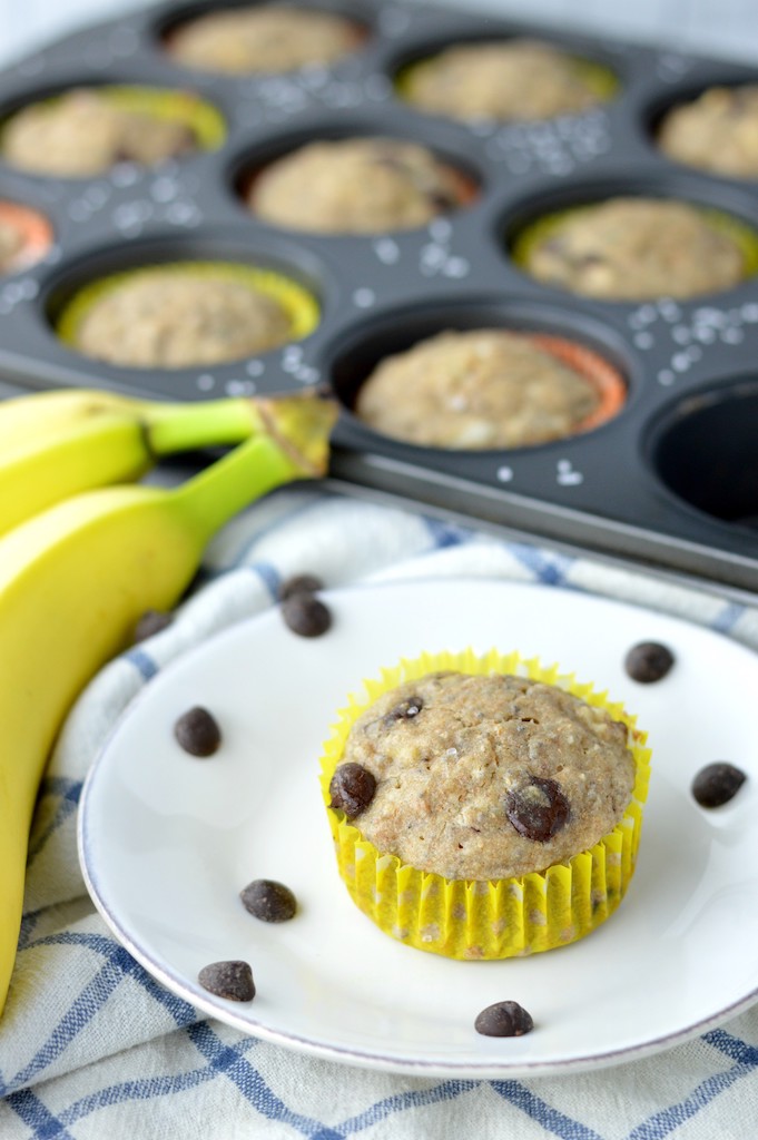 close-up of vegan banana chocolate chip muffins on white plate and muffin pan