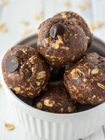 close-up of chocolate peanut butter energy balls in white ramekin