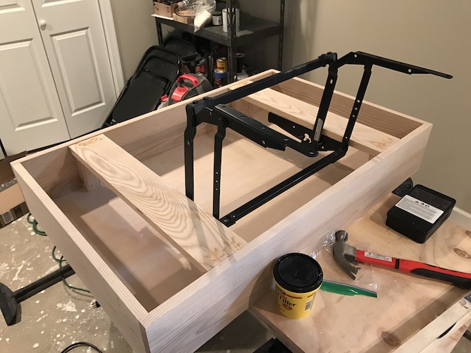 installing lift top mechanism to base of table