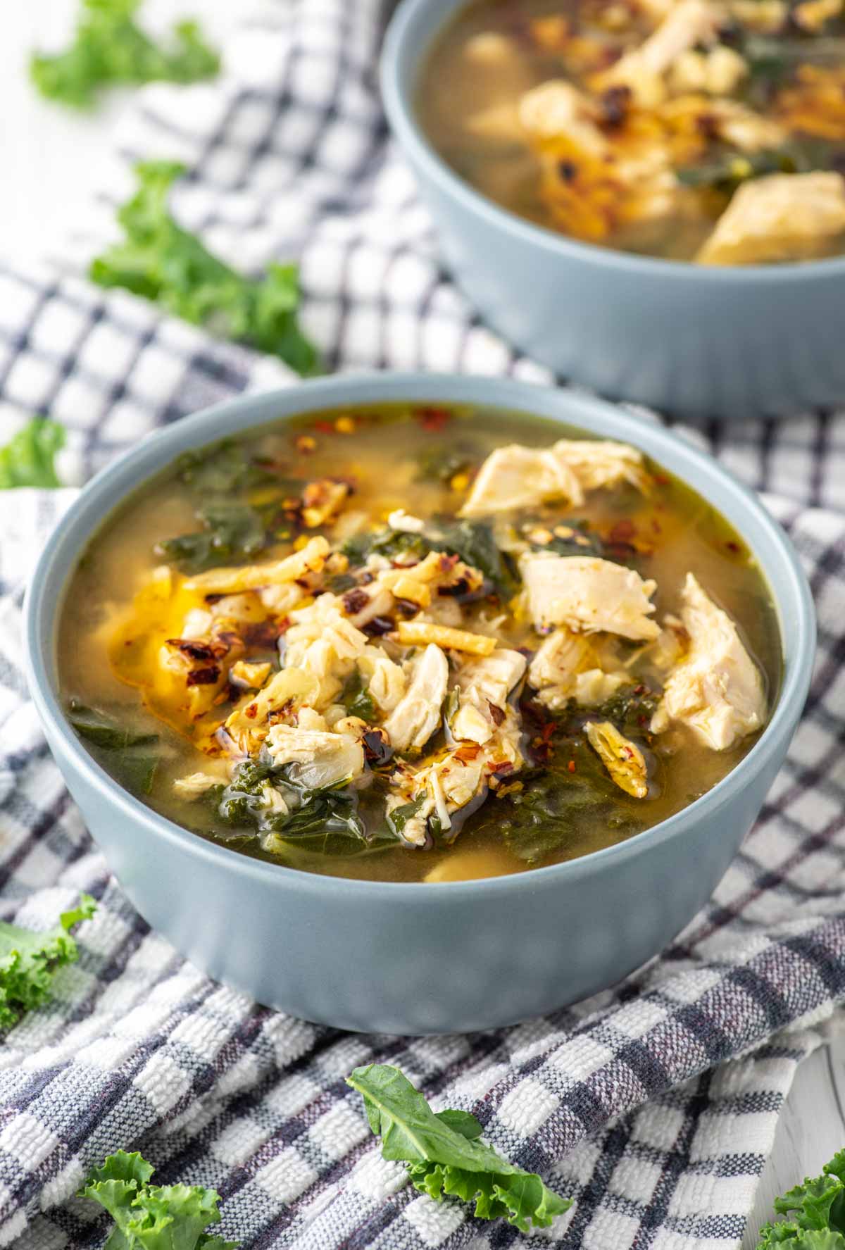 chicken barley soup in two blue bowls