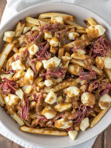 overhead shot of corned beef poutine in bowl
