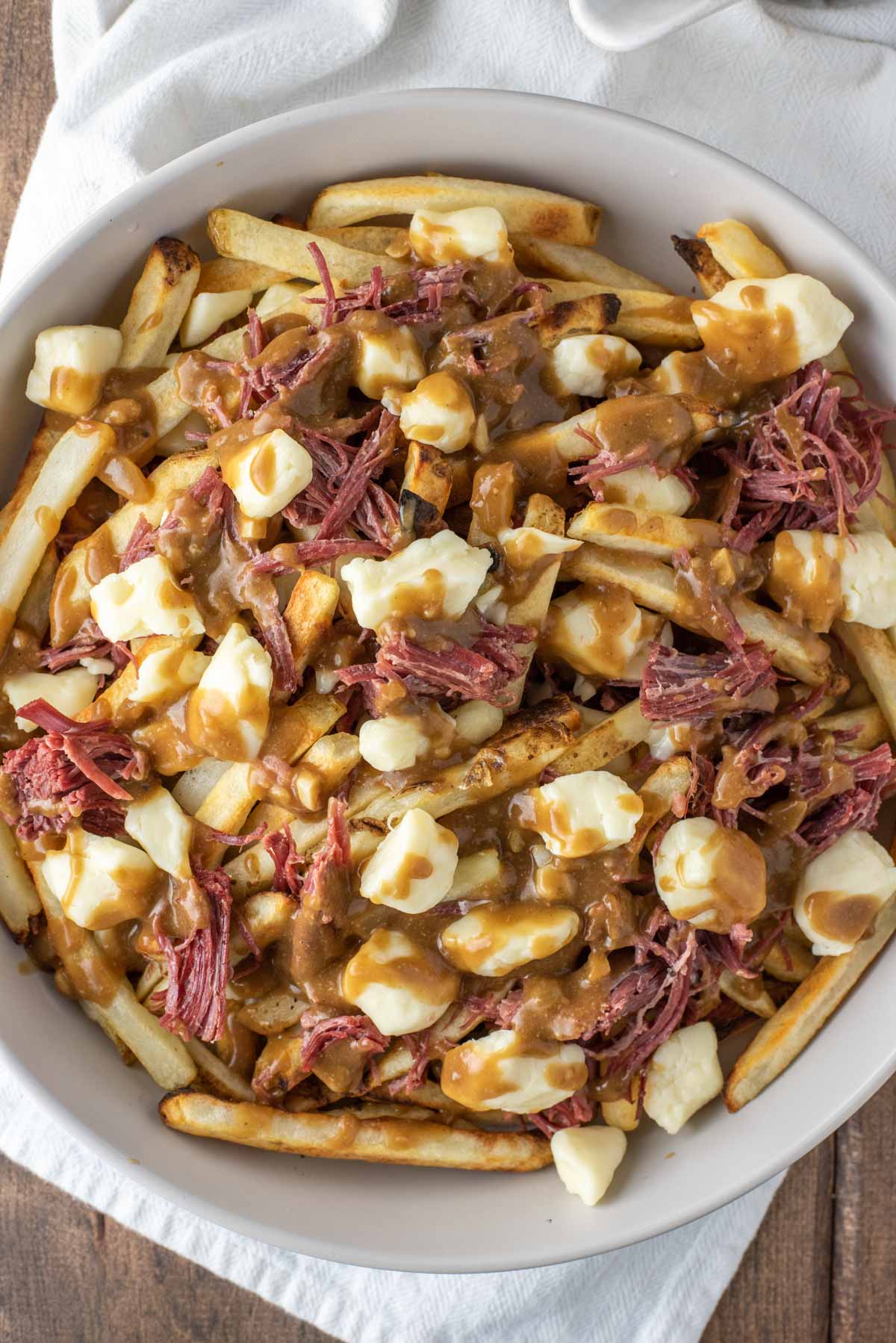 overhead shot of corned beef poutine in bowl